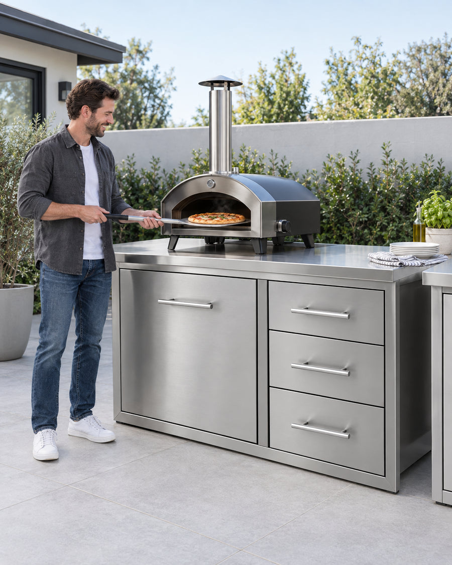 A refined suburban backyard outdoor kitchen setup featuring stainless steel countertops, built-in BBQ cabinets