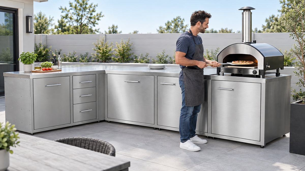 A refined suburban backyard outdoor kitchen setup featuring stainless steel countertops, built-in BBQ cabinets